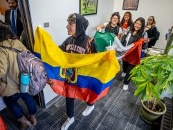 Students carry flags from Latin American countries.