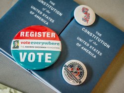 Small booklets of The Constitution of the United States of America and buttons encouraging people to vote.